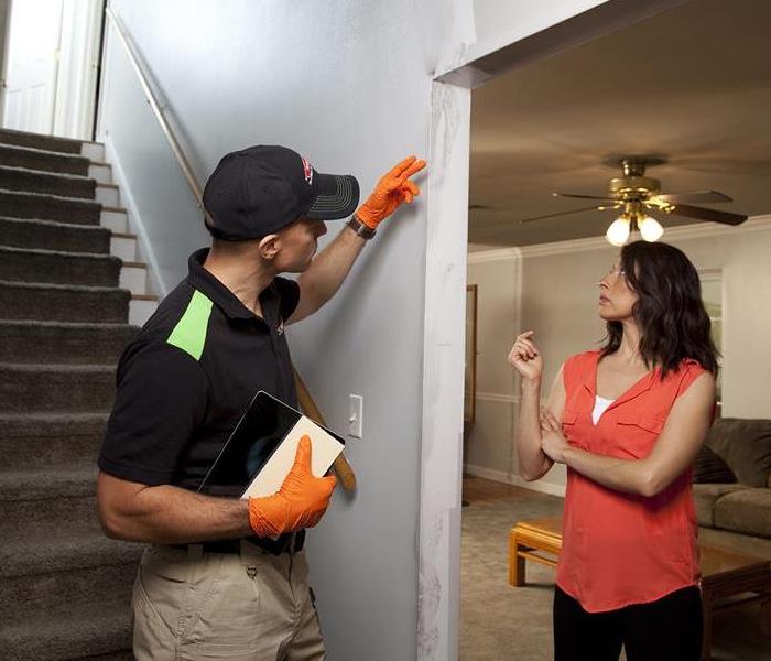 SERVPRO technician consulting homeowner about home damage